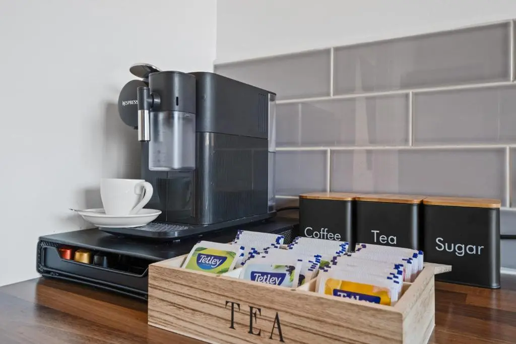 a counter with a coffee maker and a box of food at Inverness Riverside Apartment with Parking in Inverness