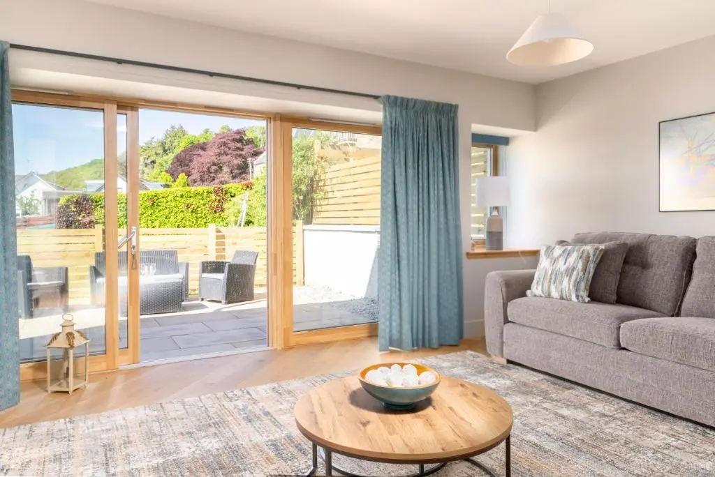 a living room with a couch and a table at Firthview Fortrose in Fortrose