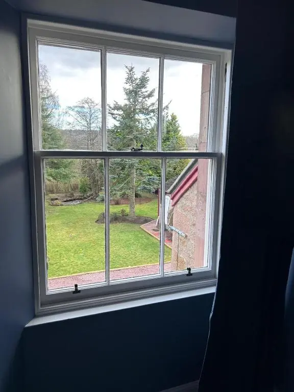a window with a view of a yard at Gruinard Guest House in Beauly