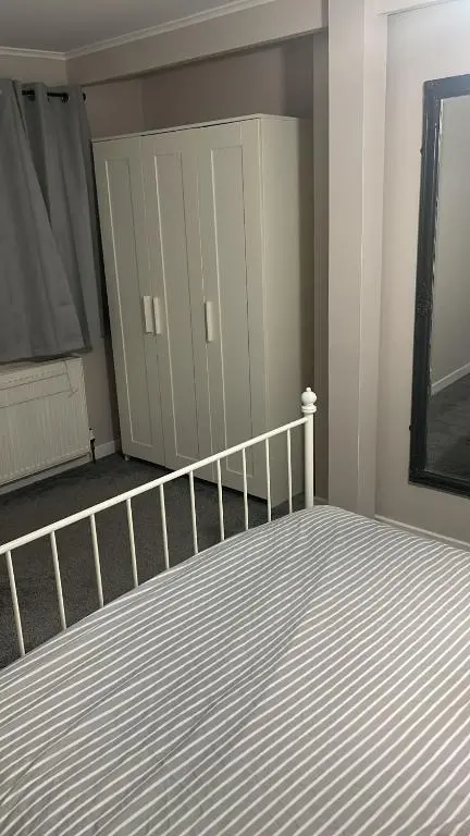 a bedroom with a large bed and a closet at Casale Peterculter in Peterculter