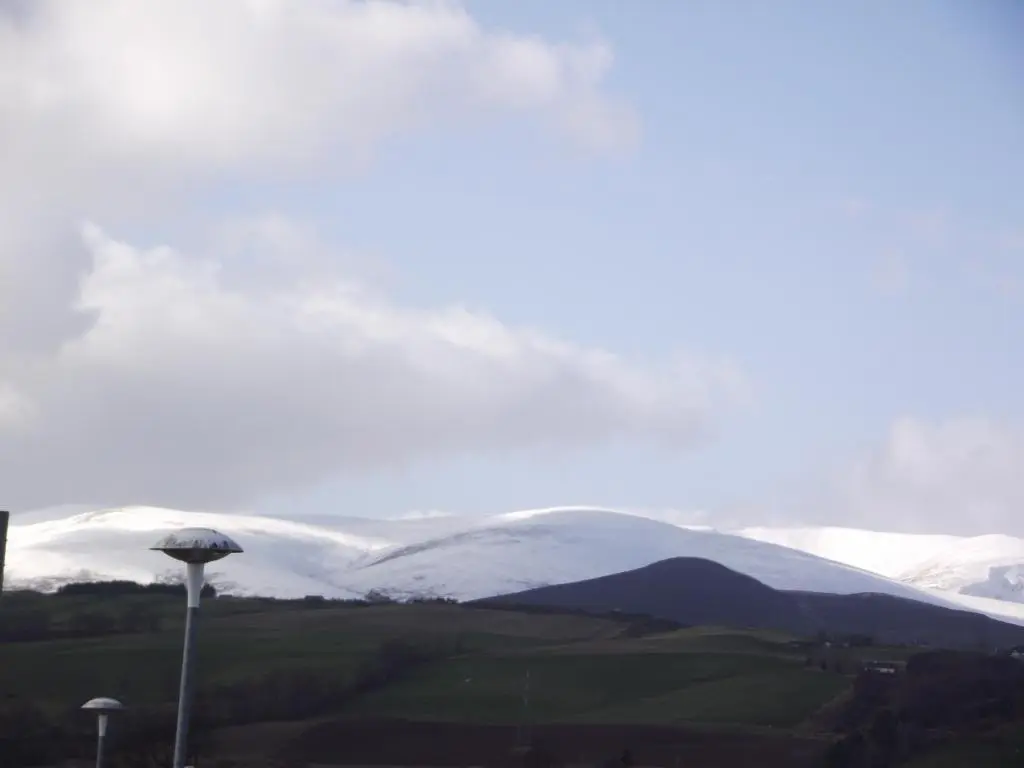 a view of snow covered mountains with a mushroom at 6B Church St. Dingwall Apartment in Dingwall