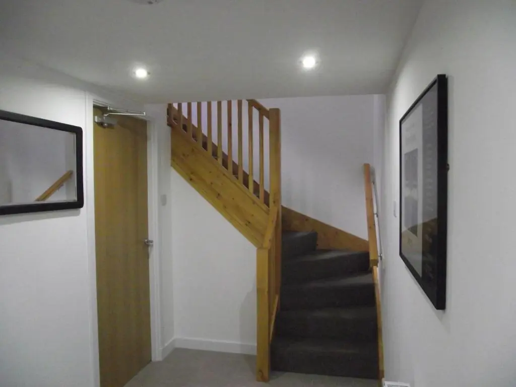 a staircase in a room with a stair case at 6B Church St. Dingwall Apartment in Dingwall