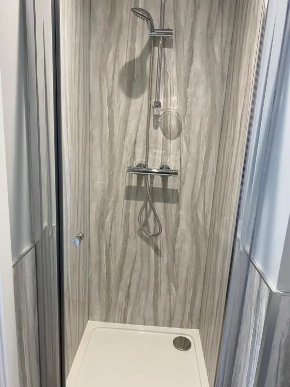 a bathroom with a shower with a glass door at Stagstone apartment in Fortrose in Fortrose