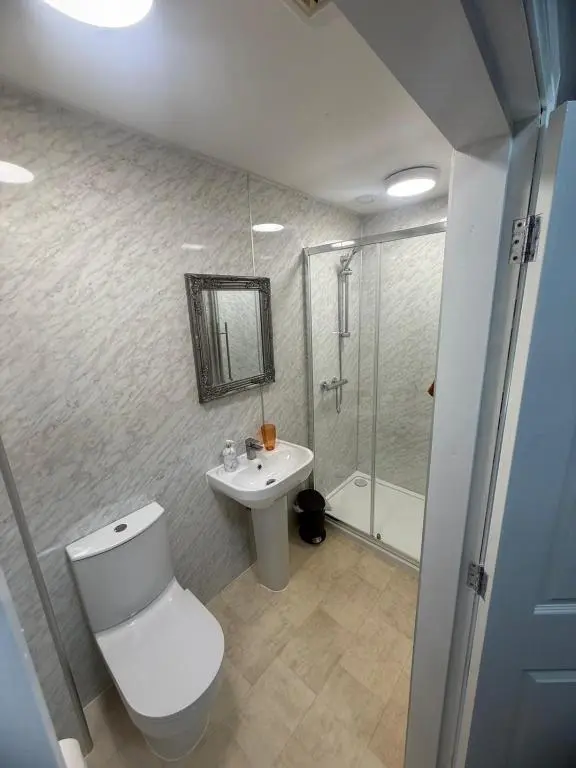 a bathroom with a toilet and a sink and a shower at The Barrel in Ballater