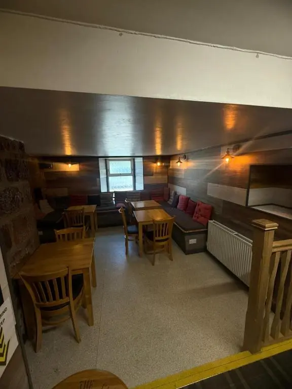 a room with tables and chairs and a couch at The Barrel in Ballater