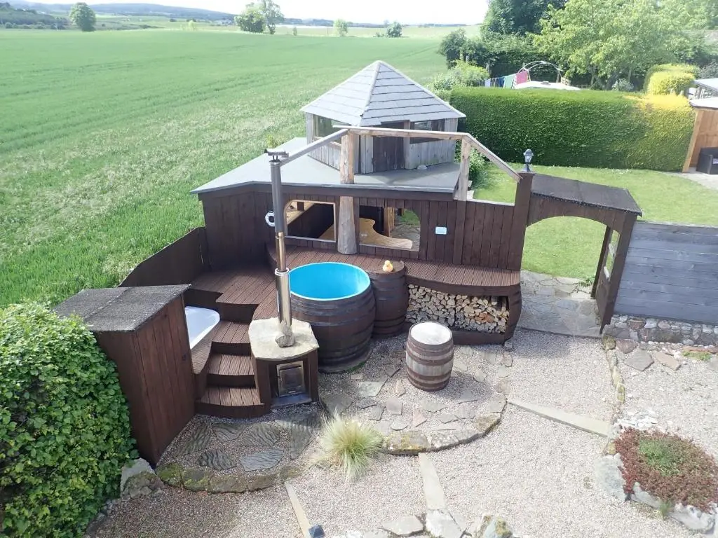 a play house with a pool in a yard at Private Speyside Tipi Retreat and Whisky Marrying Tun Hot Tub in Coltfield