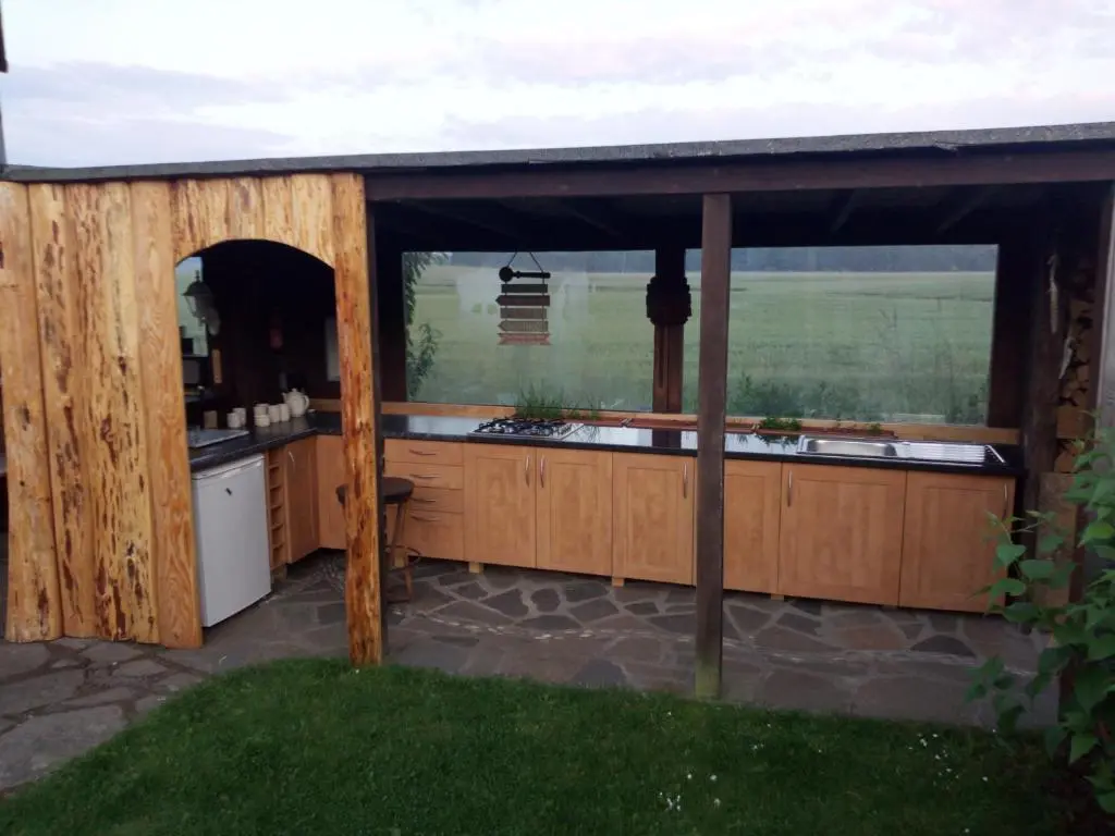 a large outdoor kitchen with a large window at Private Speyside Tipi Retreat and Whisky Marrying Tun Hot Tub in Coltfield