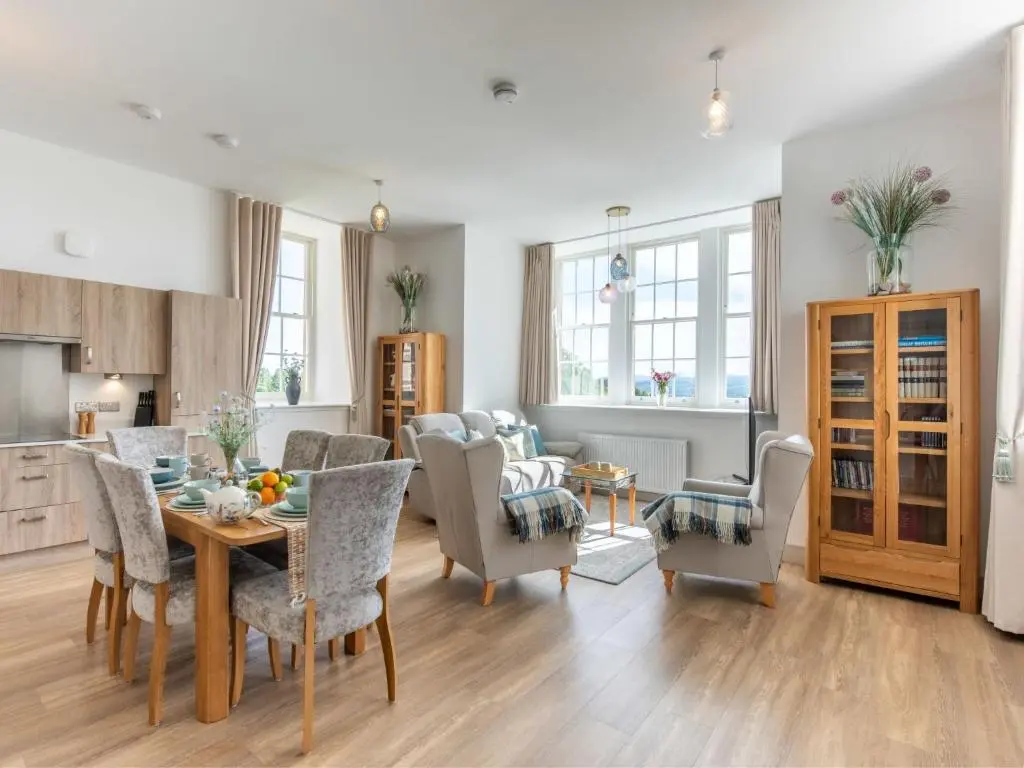 a kitchen and living room with a table and chairs at Apartment Great Glen View by Interhome in Inverness