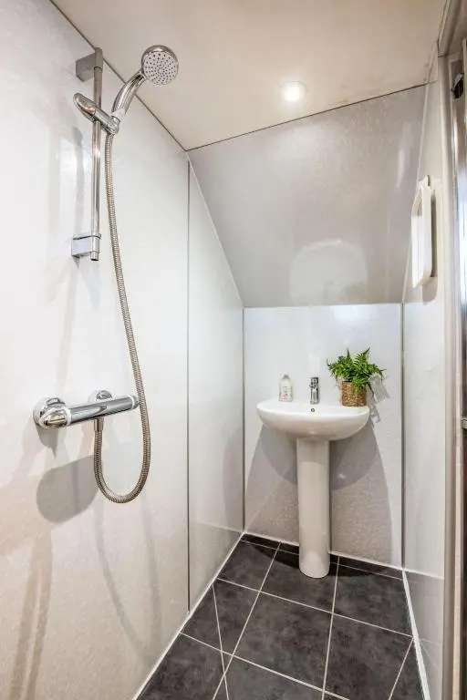 a bathroom with a sink and a shower at Holiday Home Betty's Bothy by Interhome in Drumnadrochit