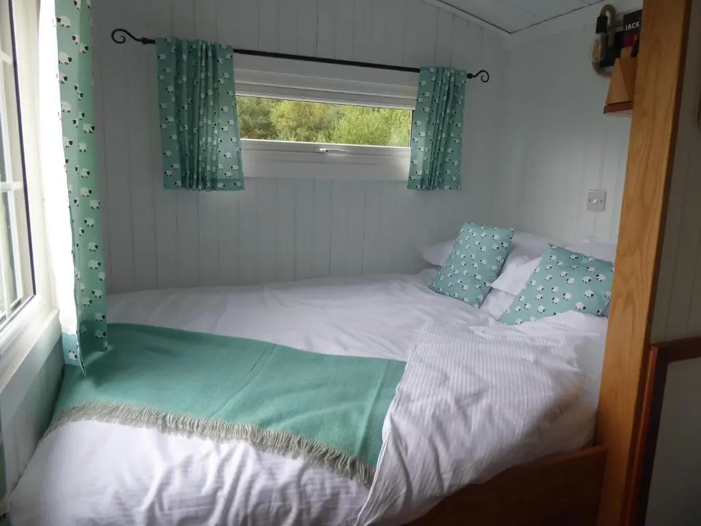 a small bed in a room with a window at Shepherds View in Glenshee