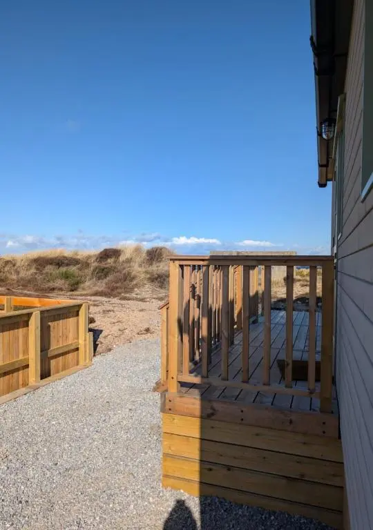 a wooden deck on the side of a building at Shephards Hut by the Beach in Findhorn