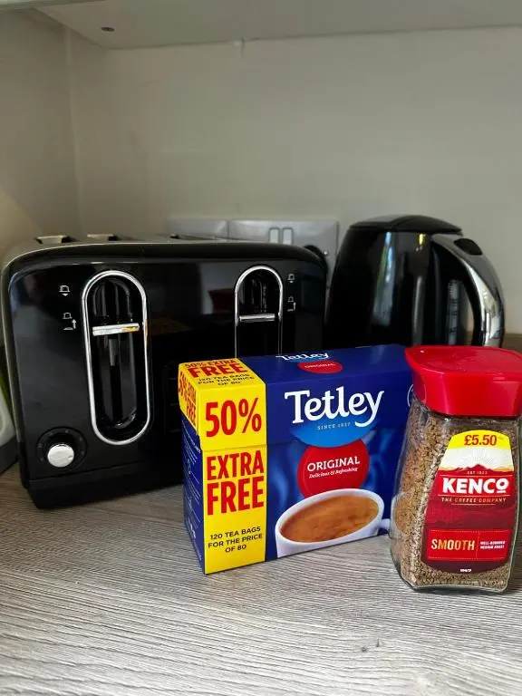 a counter with a box of seasoning and a toaster at The Ivy Nest, central in Inverness