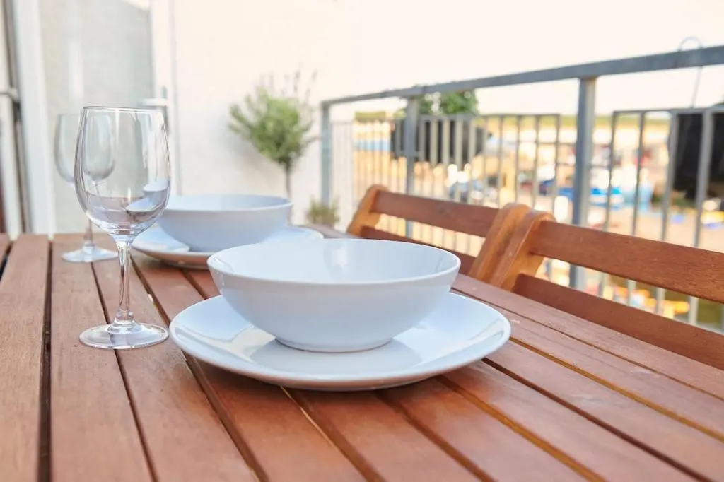 a wooden table with two bowls and a wine glass at The Sandpiper in Burghead