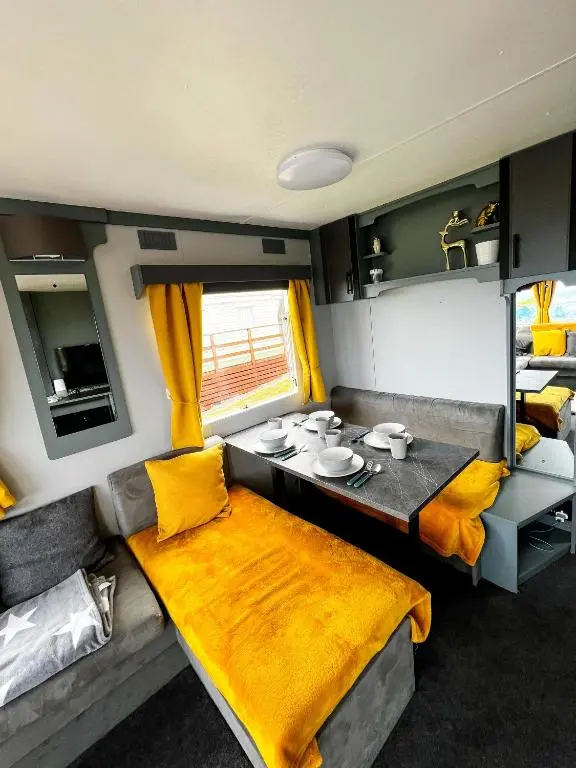 a living room with a dining table in an rv at Caravan Nr 51 Only for Family Holiday