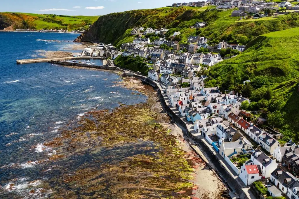 an aerial view of a village on the coast at Seabreeze Cottage, 17 Seatown, Gardenstown in Gardenstown