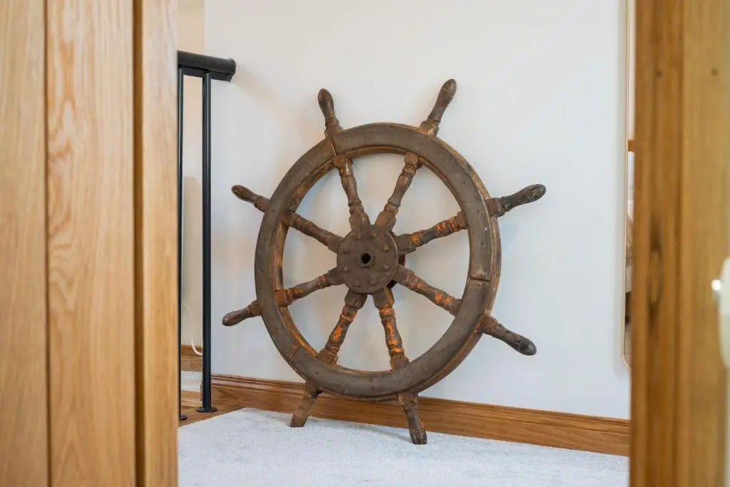an old wooden ship wheel in a room at Nautical Nook, 16 Seatown, Gardenstown in Gardenstown