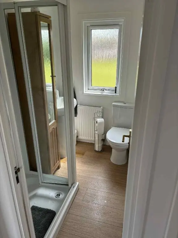 a small bathroom with a toilet and a window at Fairview Workers Accommodation in Elgin
