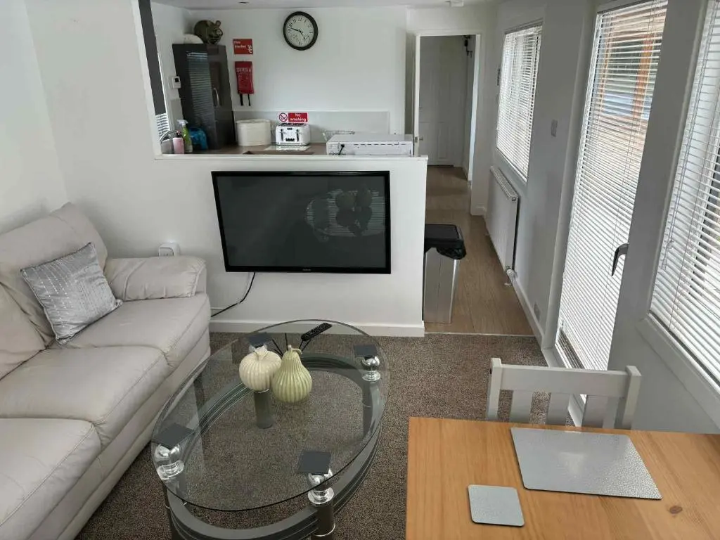 a living room with a couch and a coffee table at Fairview Workers Accommodation in Elgin
