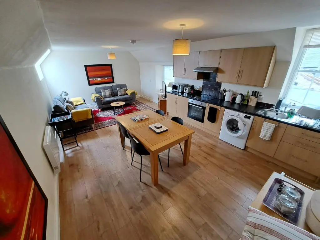 an aerial view of a kitchen and living room with a table at Tweed Apartment, Golspie in Golspie