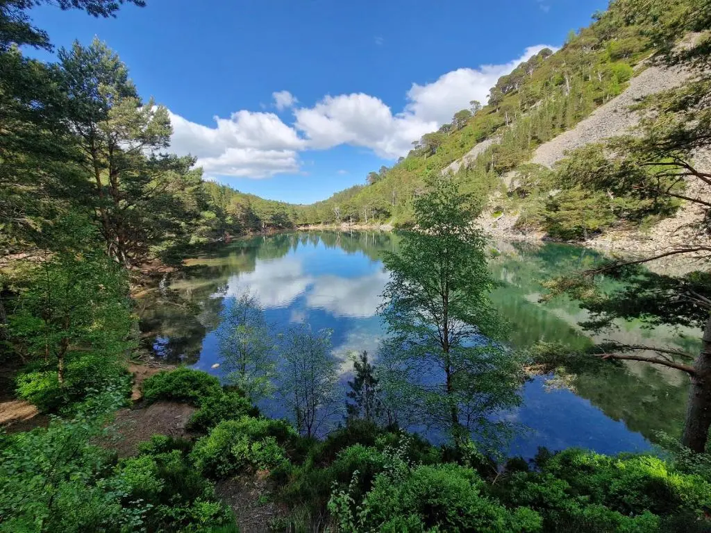 a lake in the middle of a mountain at Failte Stay in Inverness