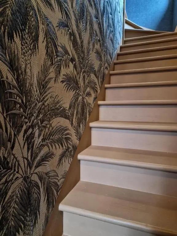a set of stairs with a wallpaper with plants at Failte Stay in Inverness