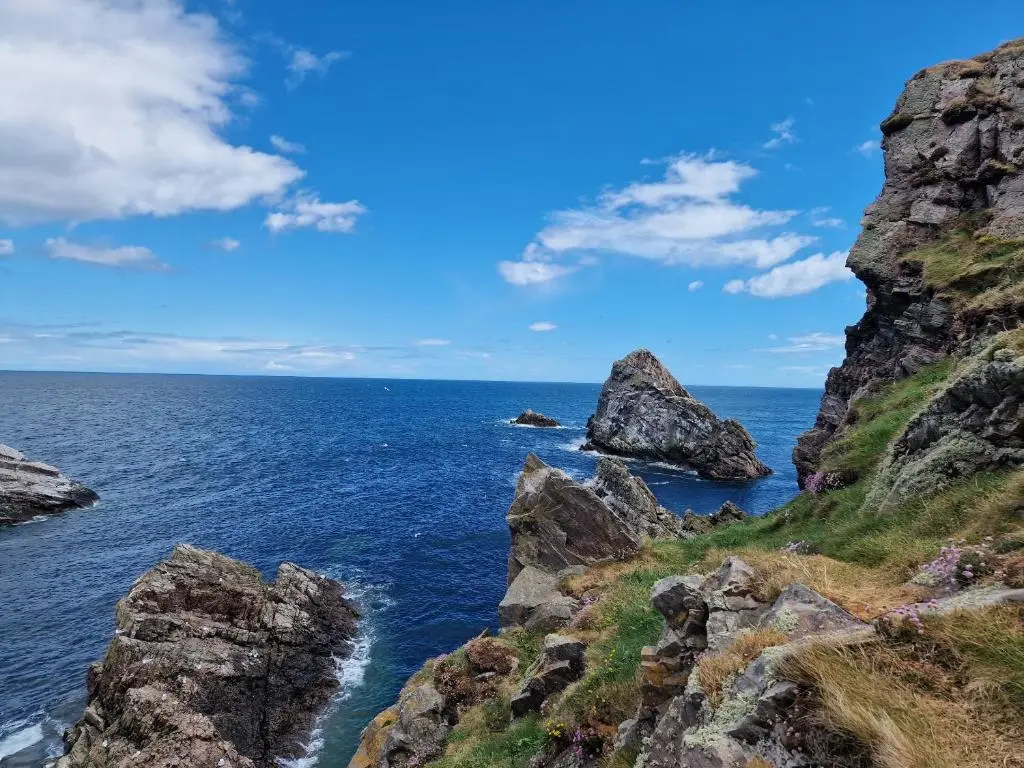 a view of the ocean with rocks in the foreground at Failte Stay in Inverness