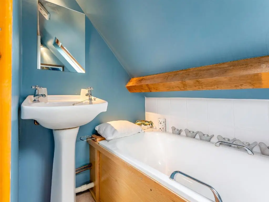 a bathroom with a sink and a bath tub at Little Tarbet in Dornoch
