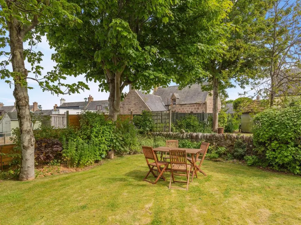 a table and two chairs in a yard at Little Tarbet in Dornoch