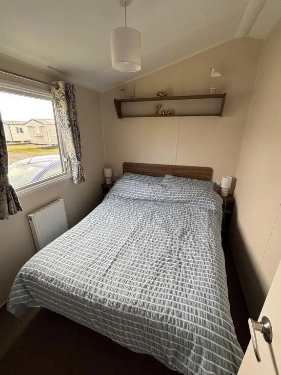 a bedroom with a bed with a checkered blanket at Sandy Shores in Embo