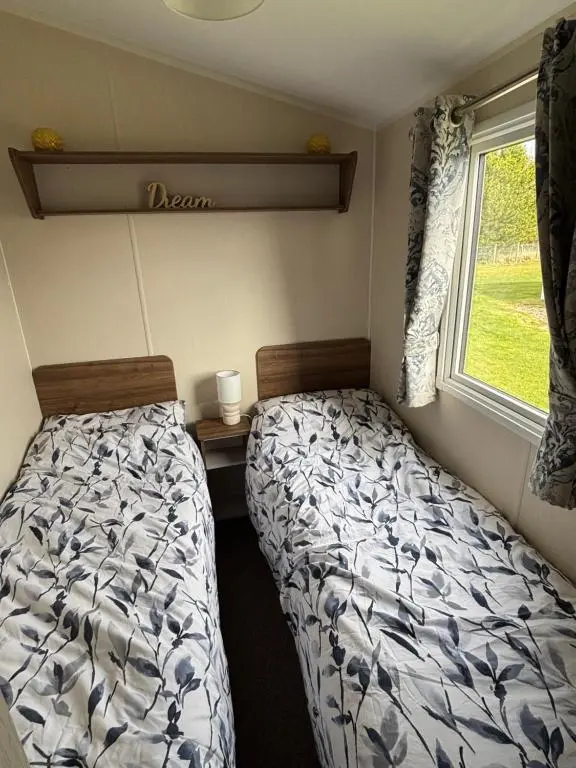 a bedroom with two beds and a window at Sandy Shores in Embo