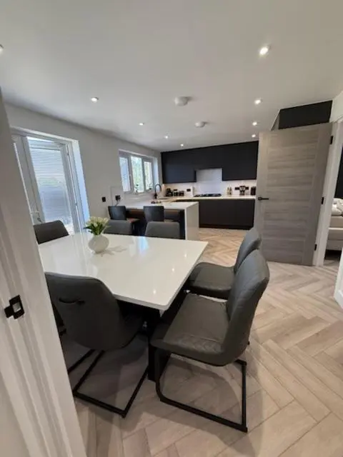 a dining room with a white table and chairs at Newly renovated house Elgin in Elgin