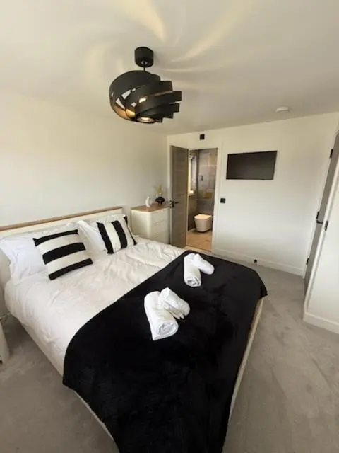 a bedroom with a bed with two towels on it at Newly renovated house Elgin in Elgin