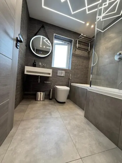 a bathroom with a sink and a toilet and a mirror at Newly renovated house Elgin in Elgin