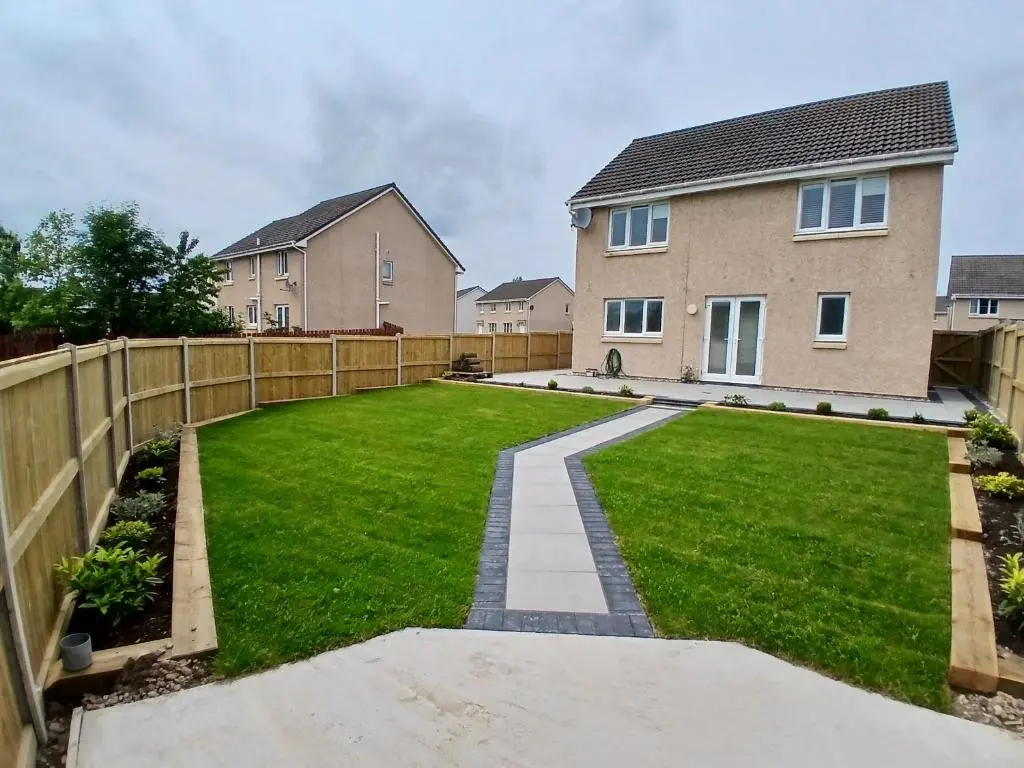 a garden with a fence and a house at Newly renovated house Elgin in Elgin