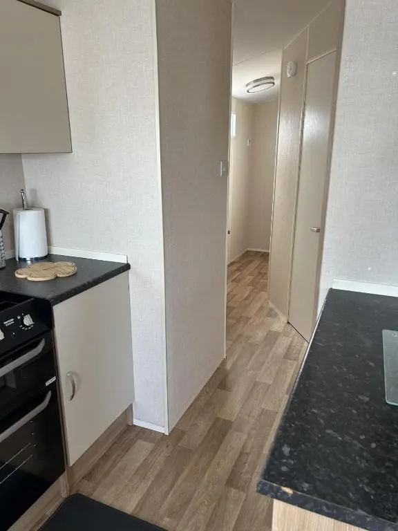 a kitchen with a stove and a counter top at A13 - Beach Haven at Silversands in Lossiemouth