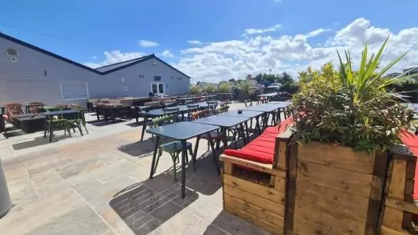 a group of tables and benches on a patio at A13 - Beach Haven at Silversands in Lossiemouth
