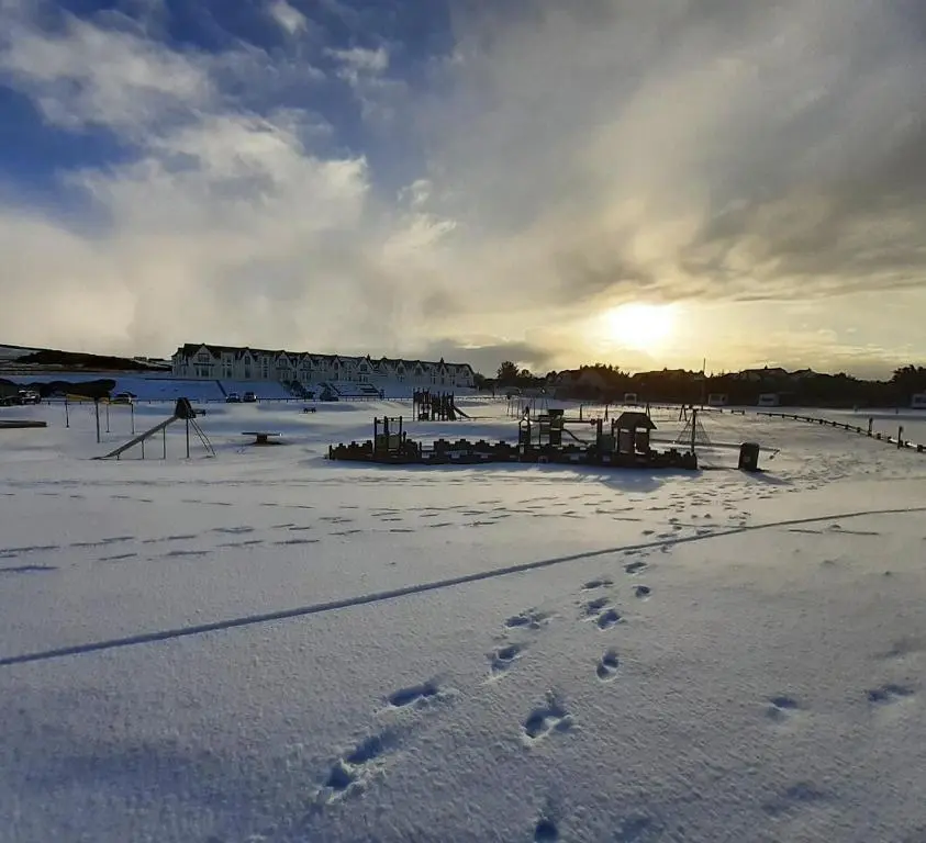 a snow covered field with footprints in the snow at Seabreeze in Whitehills