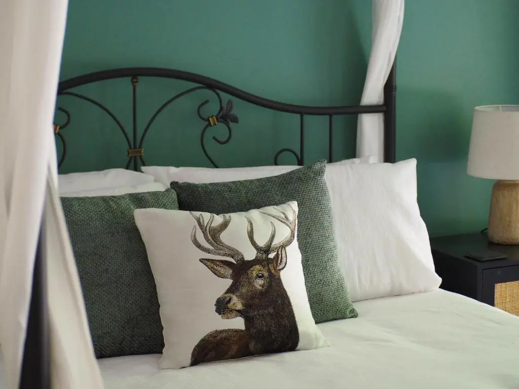 a bed with a picture of a deer on it at Coille Burn in Urray