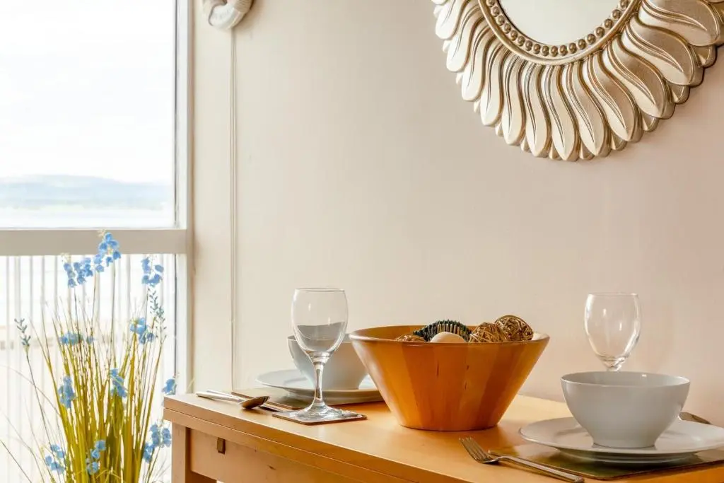 a table with two wine glasses and a bowl on it at 2 Bed in Cromarty oc-s32047 in Cromarty