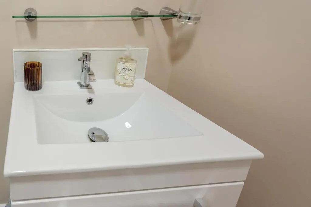 a white bathroom sink with a soap bottle on it at 2 Bed in Cromarty oc-s32047 in Cromarty