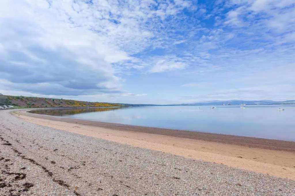 a beach with a cloudy sky and the water at 2 Bed in Cromarty oc-s32047 in Cromarty