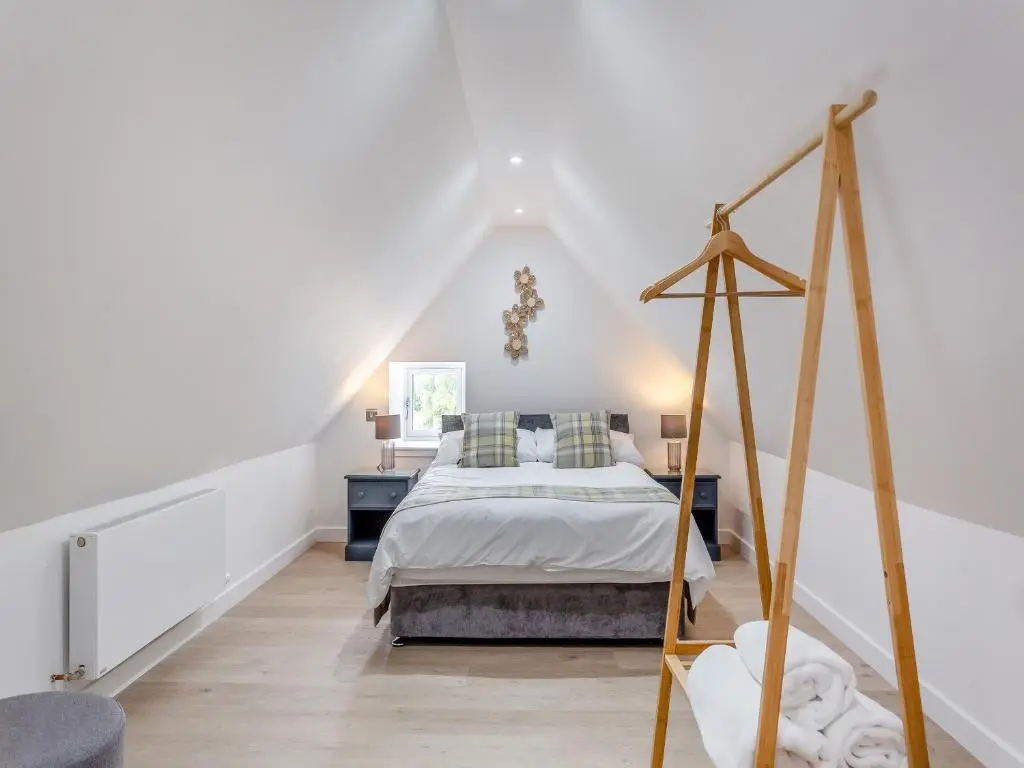 a bedroom with a bed in a attic at Ferry Cottage in Eskadale