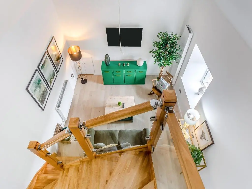 an overhead view of a living room with wood flooring at Ferry Cottage in Eskadale