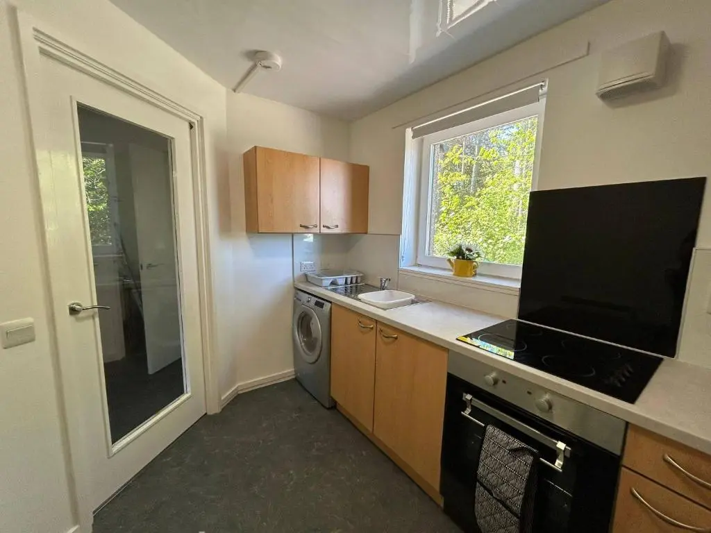 a small kitchen with a washer and dryer and a window at Two bedroom cottage in Lumsden - Contractors in Huntly
