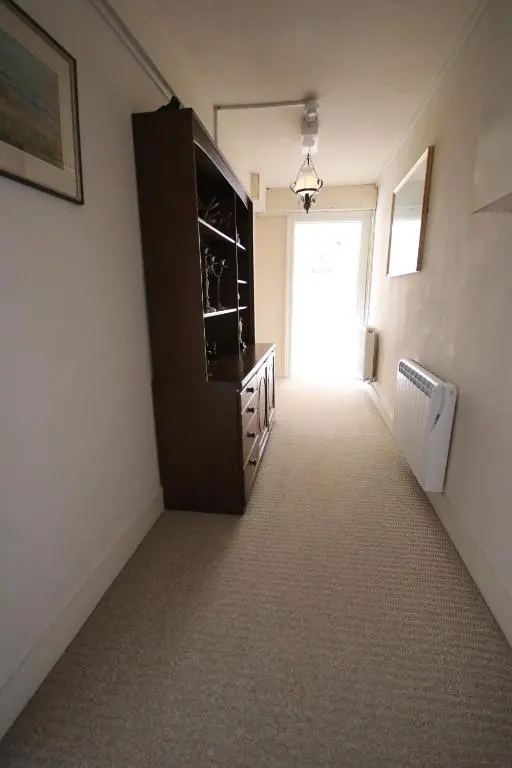 a room with a hallway with a dresser and a door at Stag View in Garve