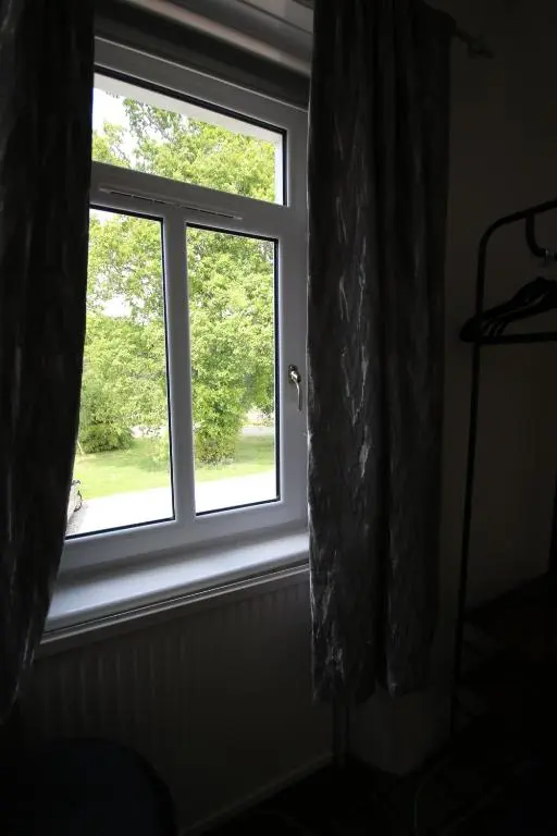 a window with a view of a yard at Stag View in Garve