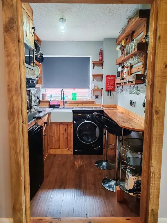 a kitchen with a sink and a washing machine at Private Holiday Home in Inverness with Free Parking l Sleeps 4 in Dalneigh