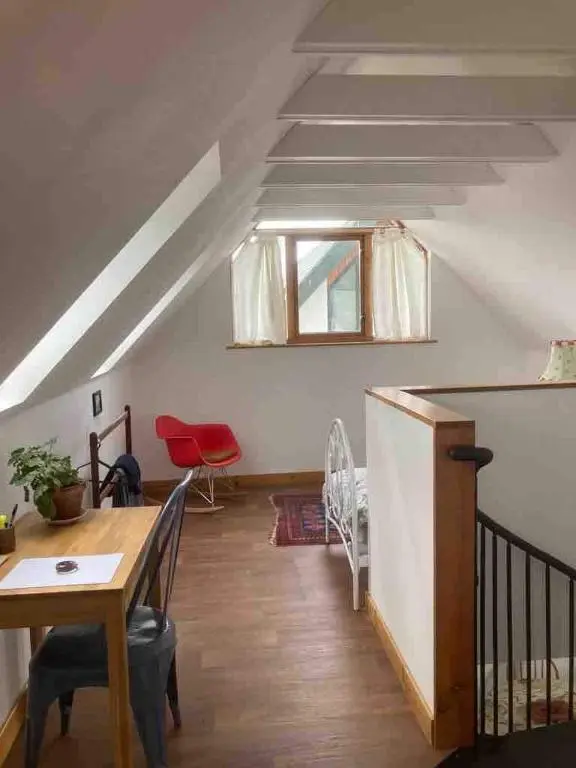 a living room with a table and chairs and a window at East Cottage, Brodie in Dyke