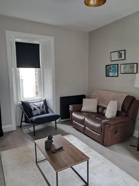 a living room with a couch and a coffee table at Granny's Hoose in Wick