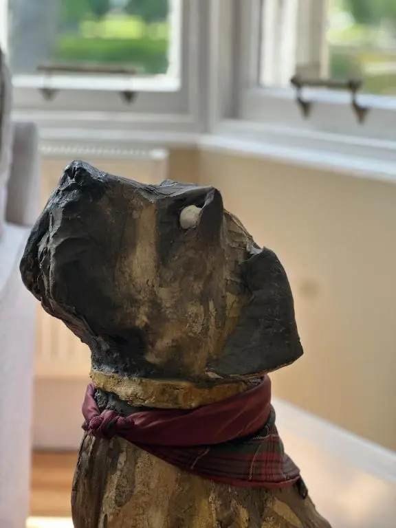 a statue of a dog with its head up at Ladies Walk - Stunning Riverfront Home in Inverness